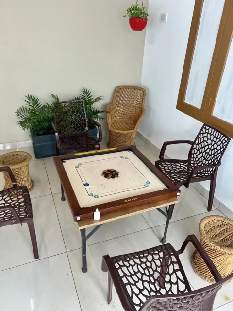 Carrom board set up with chairs