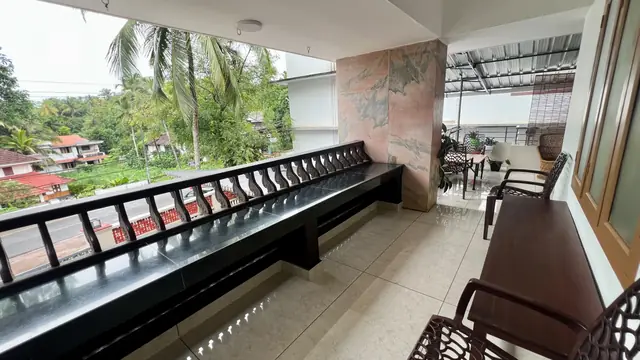 Verandah sit-out with bench seating and palm view